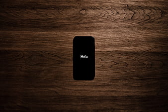 Smartphone with Hello Text on Dark Wood Background