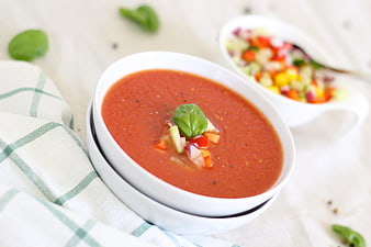 Fresh Tomato Soup with Basil and Vegetable Garnish in White Bowl