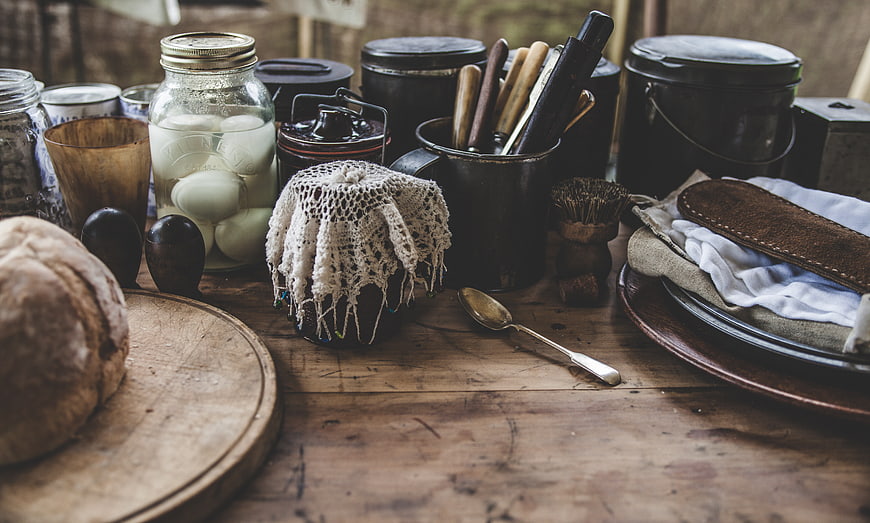 Rustic Kitchen Table with Vintage Utensils and Bread