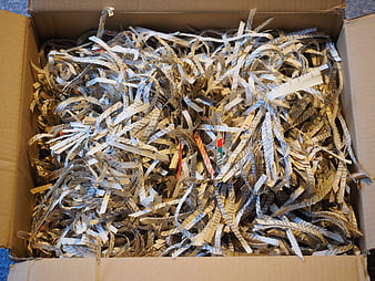 Box of Shredded Paper Strips for Recycling and Waste Disposal