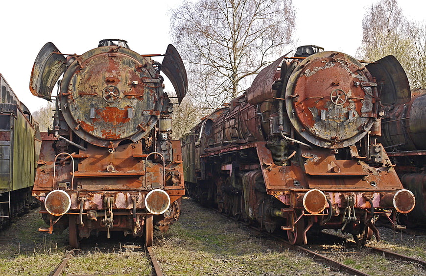 Rusty vintage steam locomotives in a train graveyard