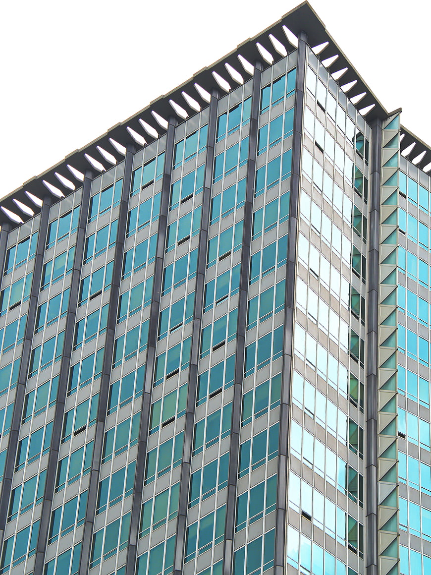 Low angle view of modern glass office building facade