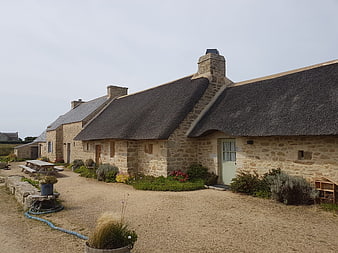 Traditional stone cottages with thatched roofs in Brittany
