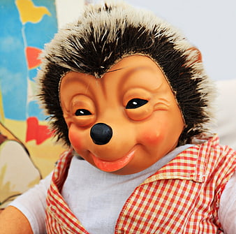 Close-up of vintage Mecki hedgehog puppet wearing red checkered vest