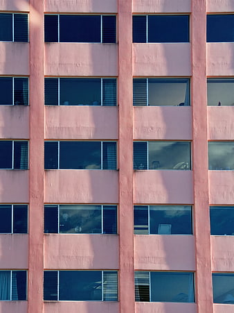 Pink Apartment Building Facade with Blue Windows
