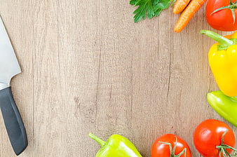 Fresh vegetables and knife on wooden table top view