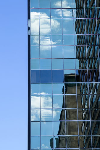 Modern Glass Skyscraper Reflections of Clouds and City