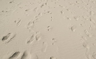 Footprints in white sand beach texture background