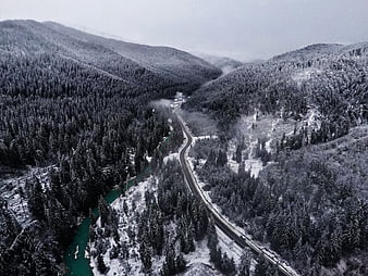 Aerial View of Snowy Mountain Road and Turquoise River