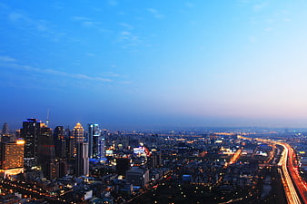 Aerial View of Taichung City Skyline at Dusk with Highway Traffic