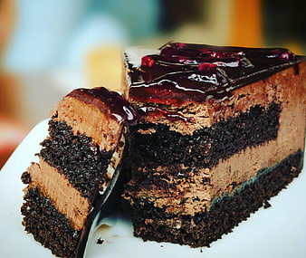 Close-up of layered chocolate cake with berry glaze