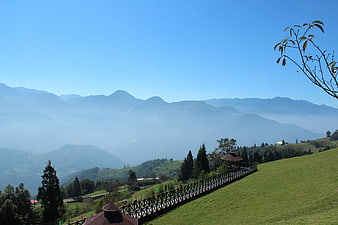 Scenic mountain landscape with wooden walkway and blue sky