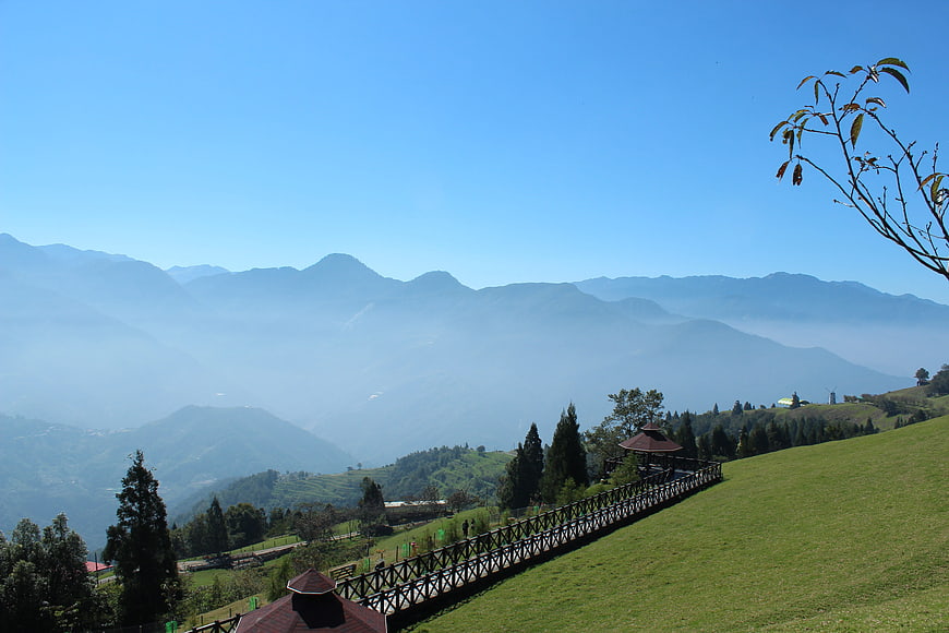 Scenic mountain landscape with wooden walkway and blue sky
