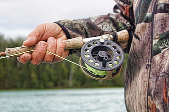 Close-up of Fly Fishing Reel and Rod in Camouflage