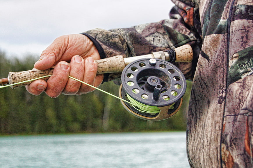 Close-up of Fly Fishing Reel and Rod in Camouflage