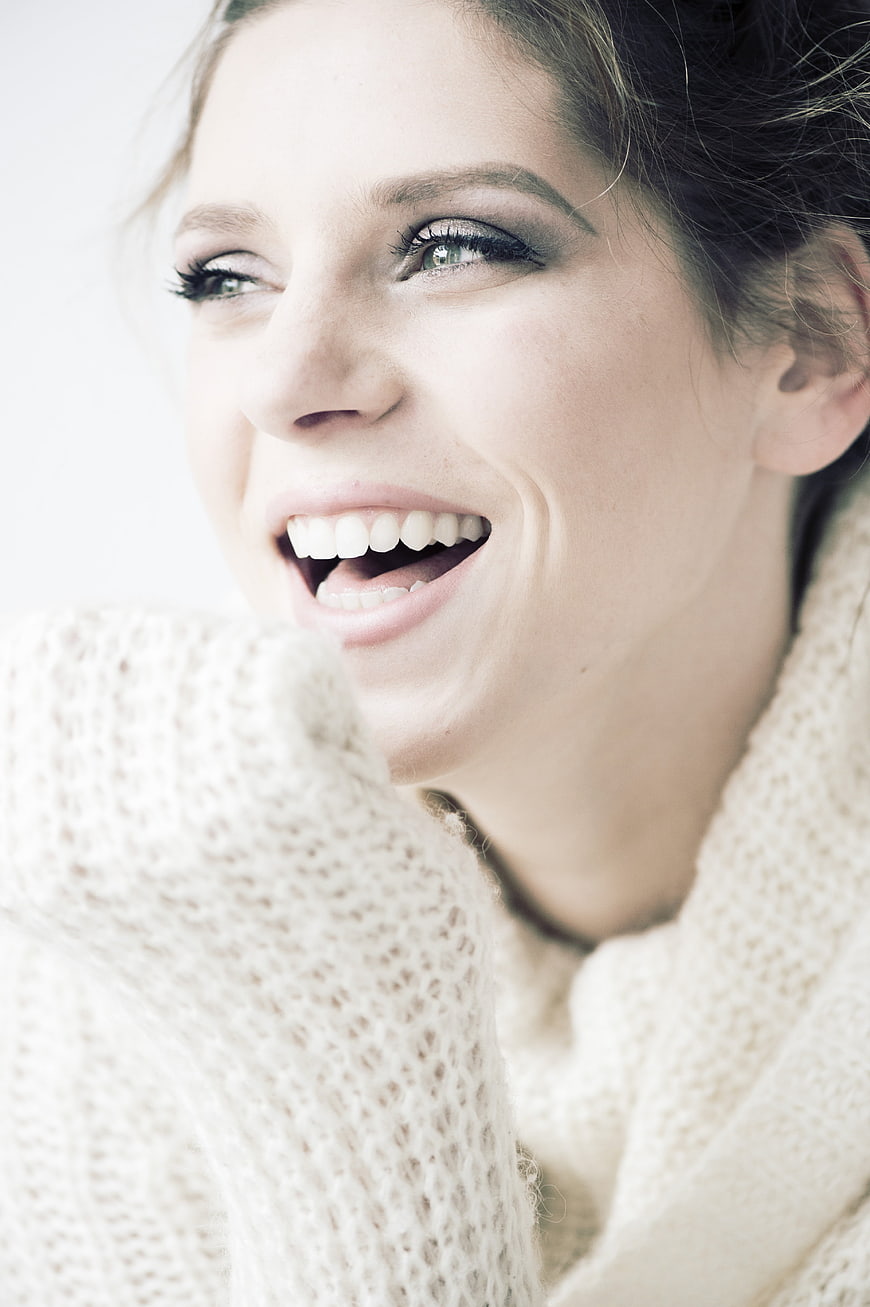 Close-up Portrait of Happy Woman Laughing in Knit Sweater