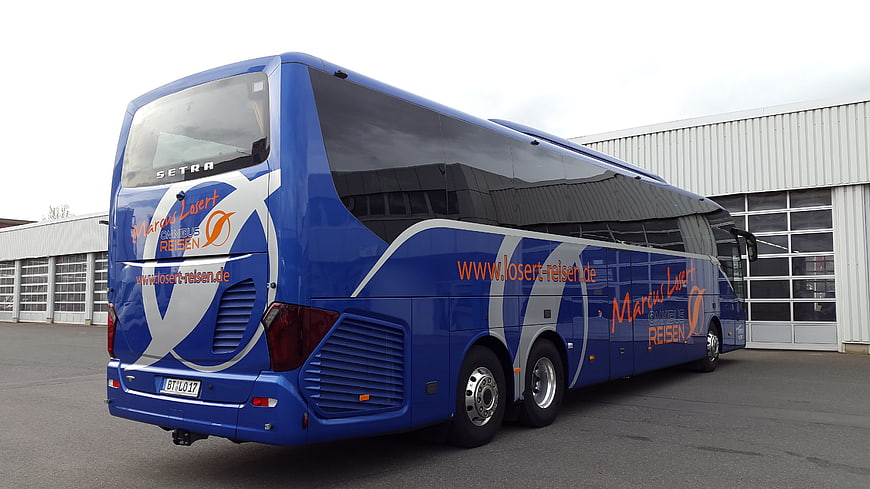 Blue Setra Coach Bus Parked Outside Industrial Building