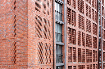 Modern Red Brick Building Facade with Geometric Patterns