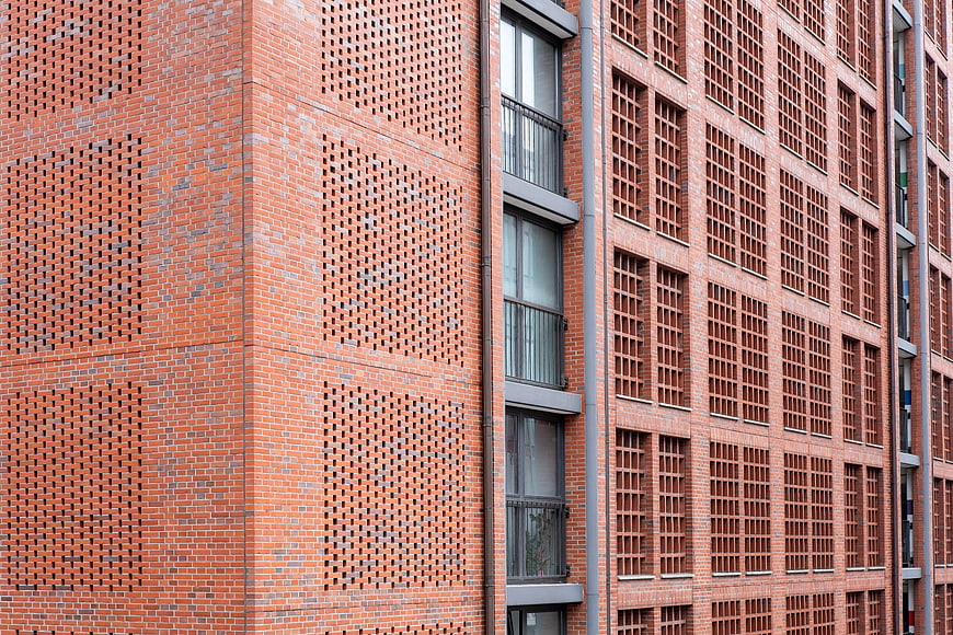 Modern Red Brick Building Facade with Geometric Patterns