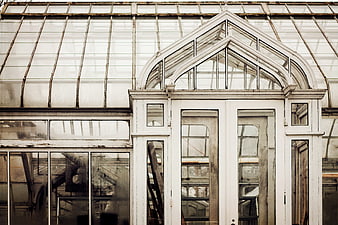 Vintage greenhouse architecture with arched glass windows