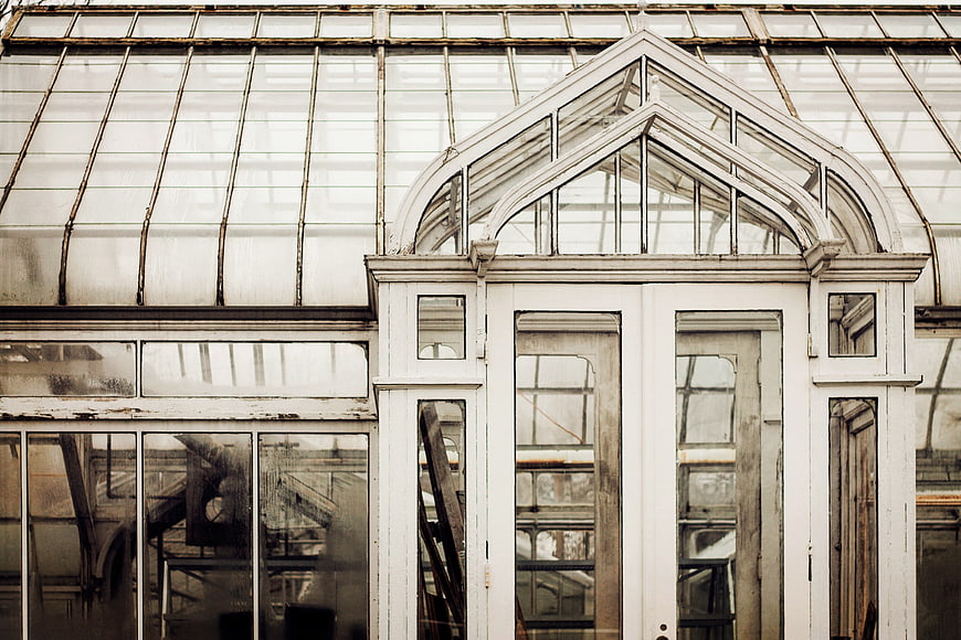 Vintage greenhouse architecture with arched glass windows