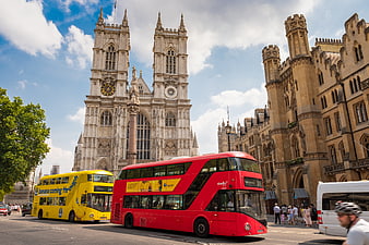 Red and Yellow Double-Decker Buses in Front of Westminster Abbey London