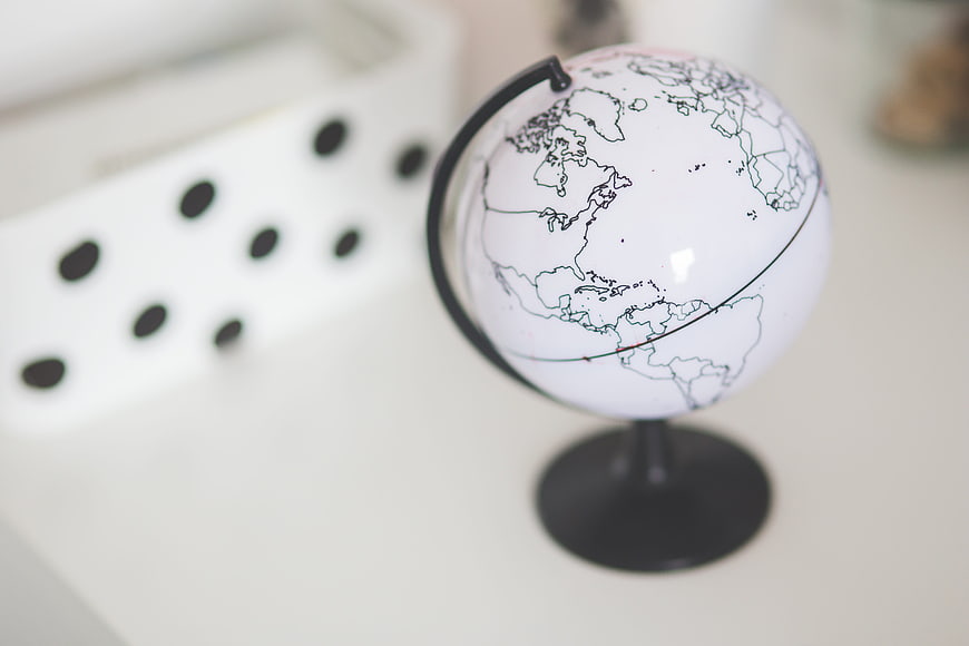 Minimalist white globe on desk with blurred background