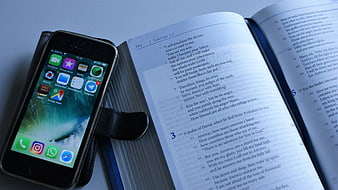Smartphone and Open Tehillim Book on Blue Surface