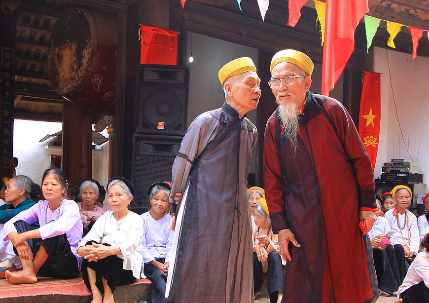 Elderly Men in Traditional Attire at Vietnamese Village Festival