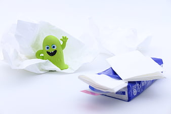 Green Germ Toy With Tissues On White Background