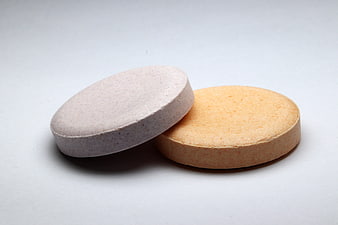 Two Pharmaceutical Tablets On White Background