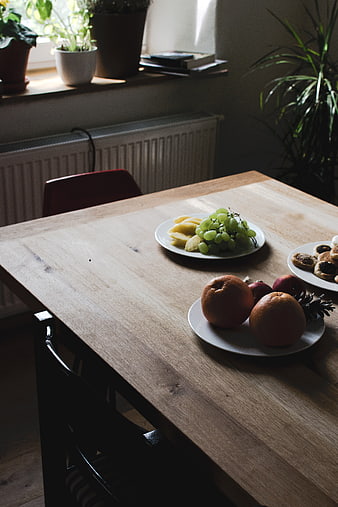 Fresh fruit and pastries on a wooden dining table