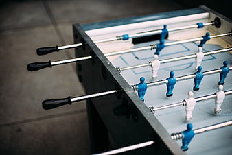 Close-up of blue and white foosball table players