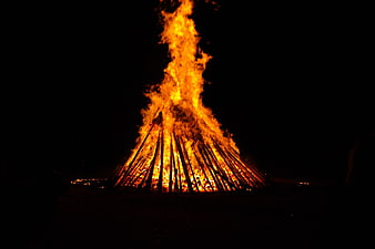 Large Bonfire Burning Brightly Against Dark Night Sky