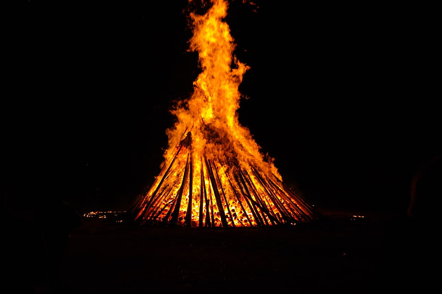 Large Bonfire Burning Brightly Against Dark Night Sky