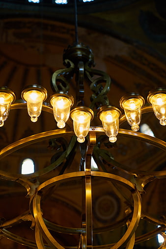 Close-up of ornate brass chandelier with glowing bulbs