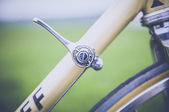 Close-up of vintage bicycle gear shifter on gold frame