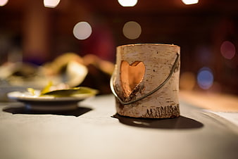 Birch bark candle holder with heart cutout on table