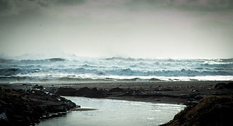 Dramatic Stormy Ocean Waves Crashing on Rocky Beach