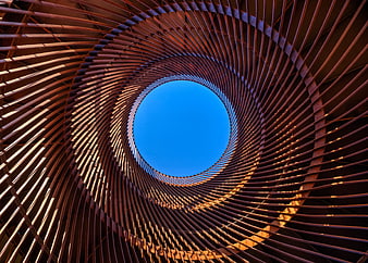 Spiral metal structure looking up at blue sky