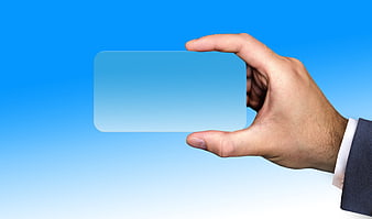 Hand holding blank business card on blue background