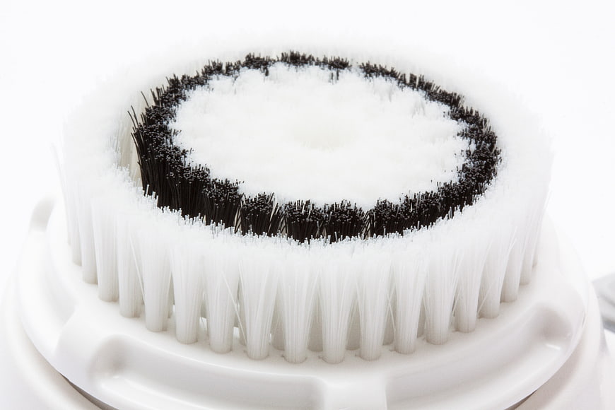 Close-up of white and black sonic facial cleansing brush head