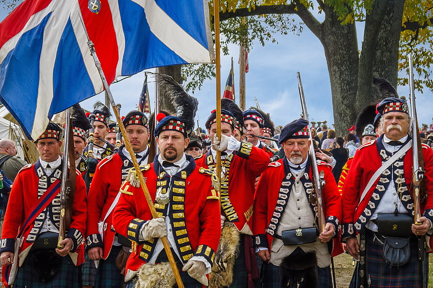 Scottish Highlanders in Traditional Red Military Uniforms Marching