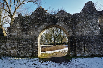 Ancient Stone Arch Ruins In Snowy Winter Landscape