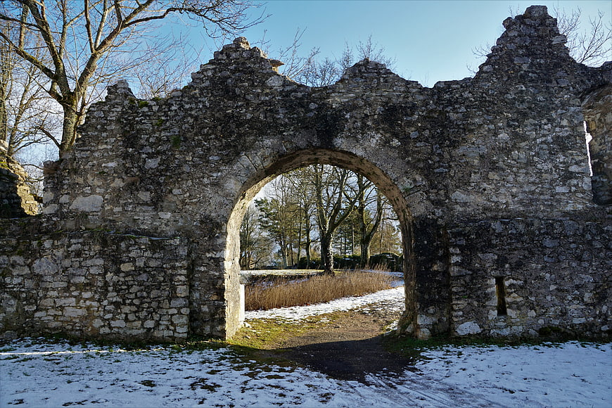 Ancient Stone Arch Ruins In Snowy Winter Landscape