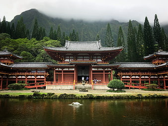 Traditional Japanese Temple by Lake with Mountain Background