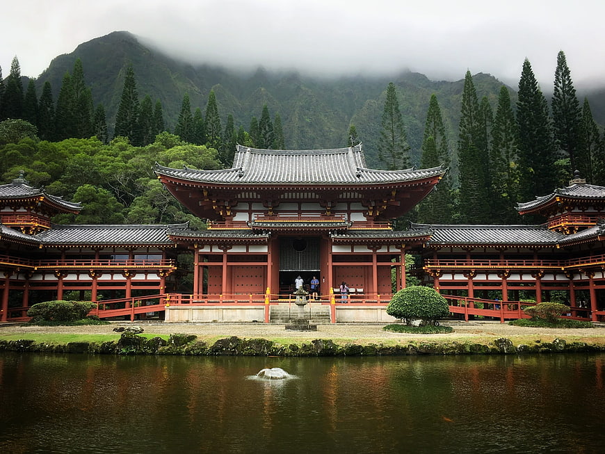 Traditional Japanese Temple by Lake with Mountain Background