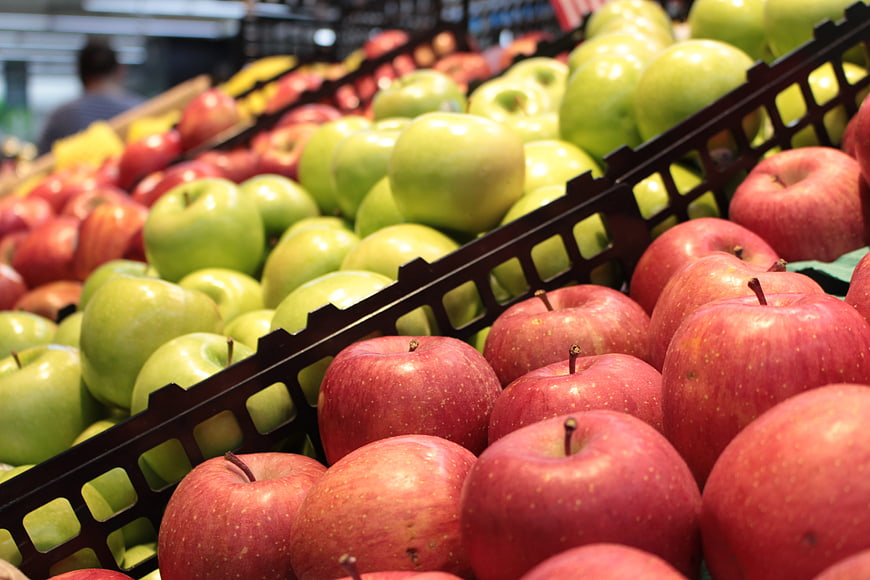 Fresh Red And Green Apples In Supermarket Display Bins