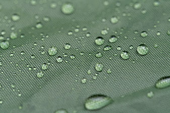 Macro water droplets on green waterproof tent fabric