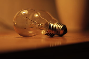Close-up of incandescent light bulbs on wooden surface